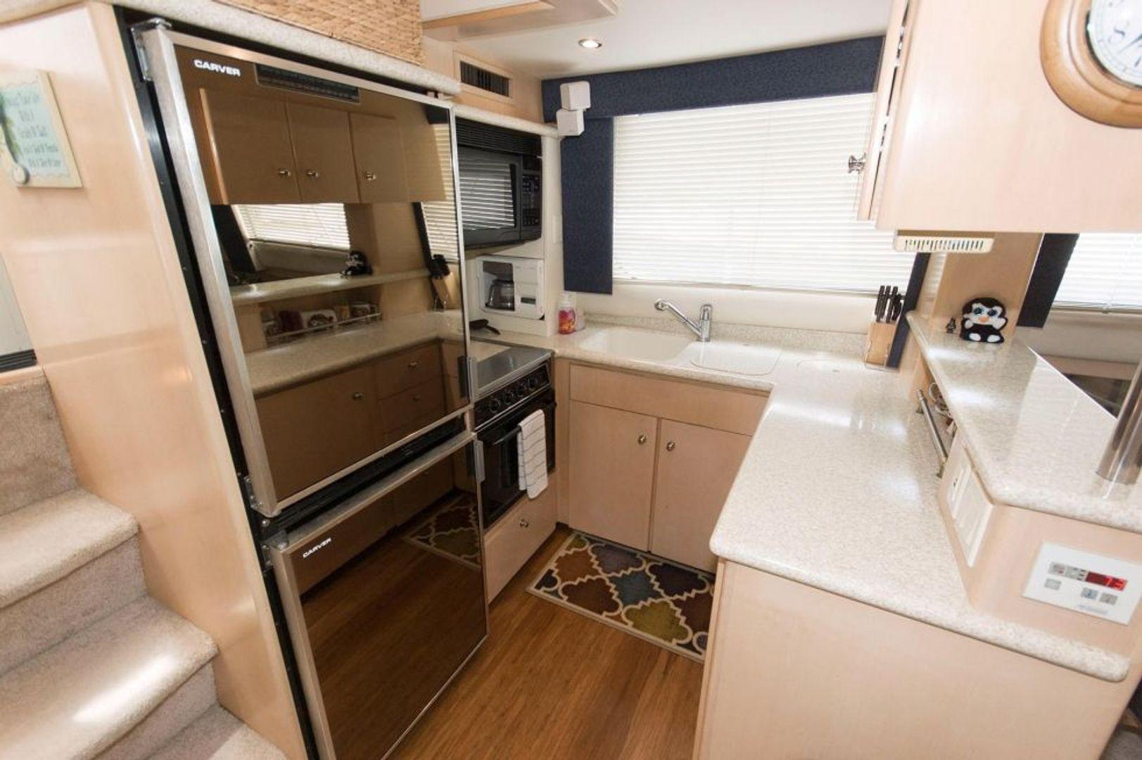 Galley down on port side. Refrigerator on top. Freezer on bottom. Convection microwave. Built in coffee maker. Stove/range has been upgraded in 2021. 