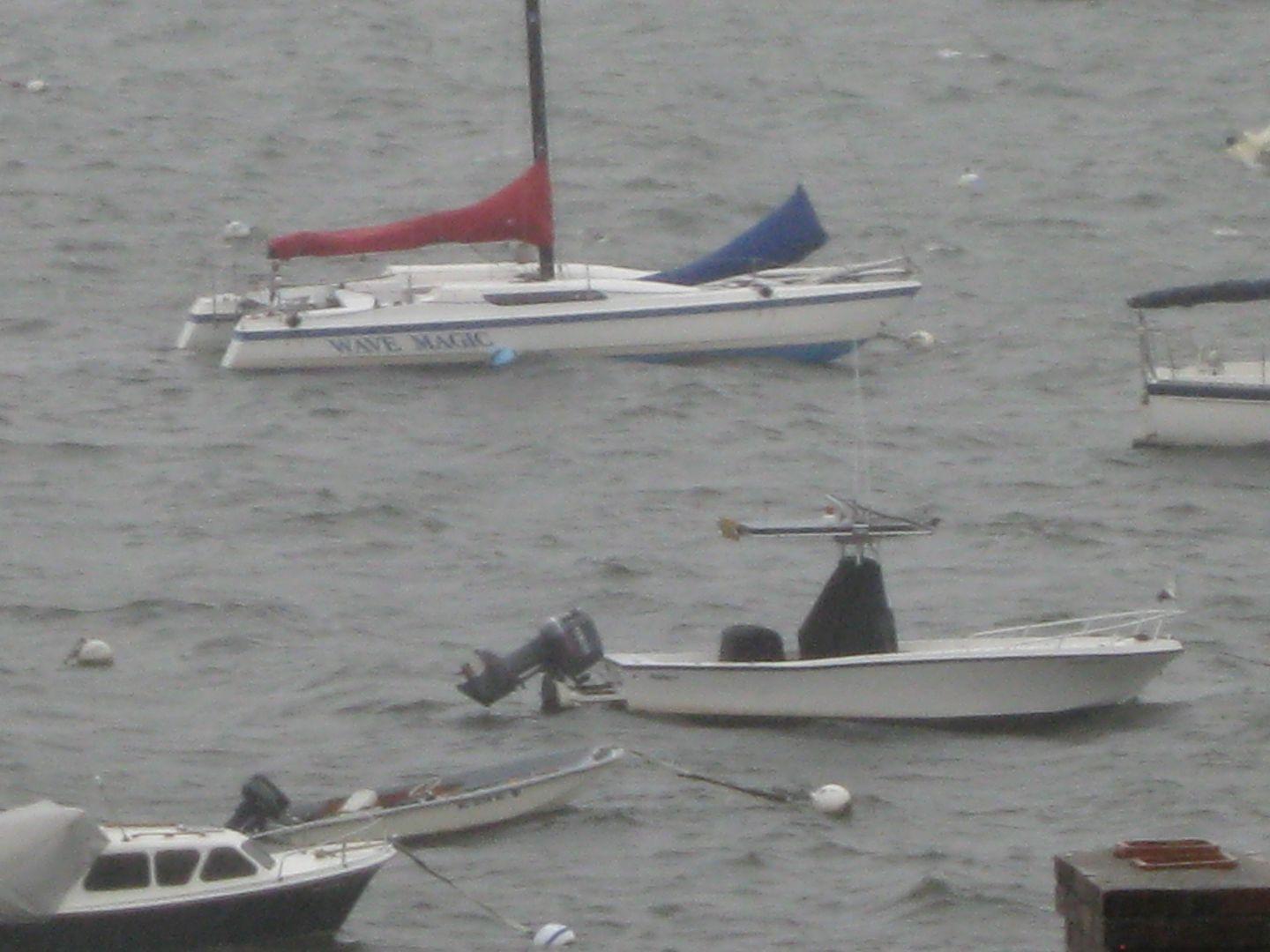 Riding out a storm at its mooring in Salem Harbor.  It does excellent in any strength storm due to mooring system and small wind frontage profile resistance.