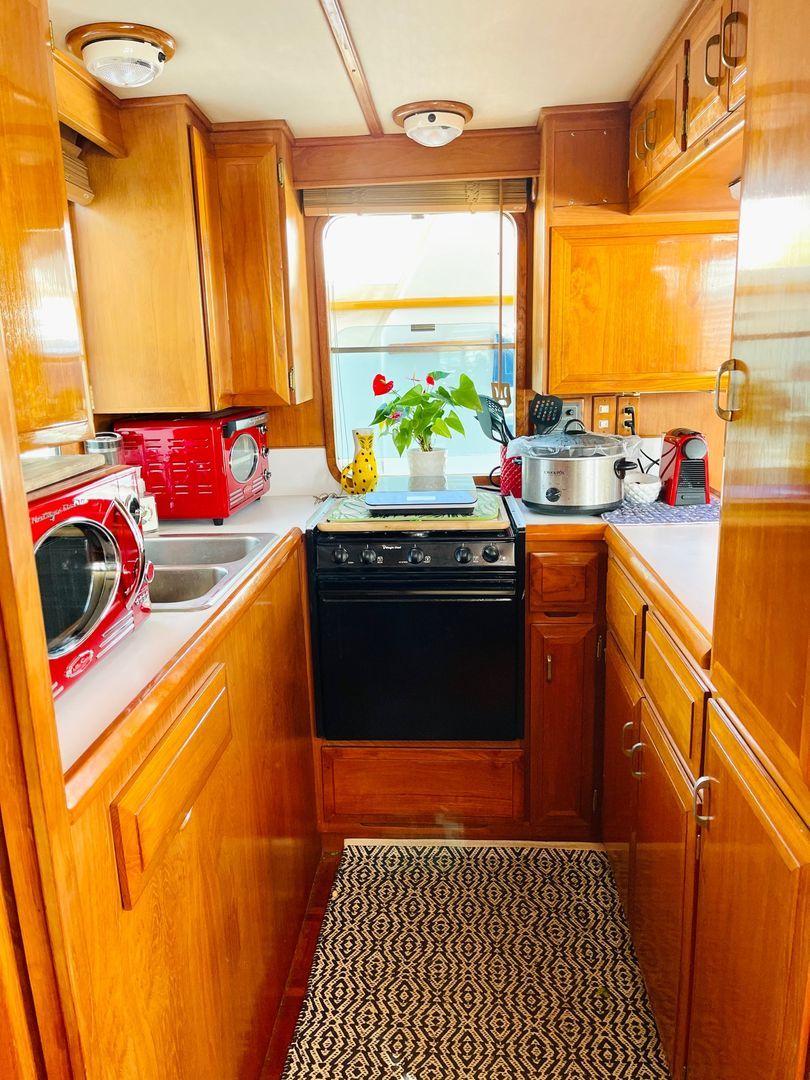 The galley offers plenty of cabinets and counter space, plus two windows to let the breeze in.